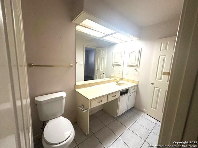 bathroom with tile patterned floors, vanity, and toilet