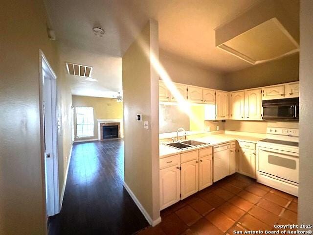 kitchen featuring white appliances, white cabinetry, and sink