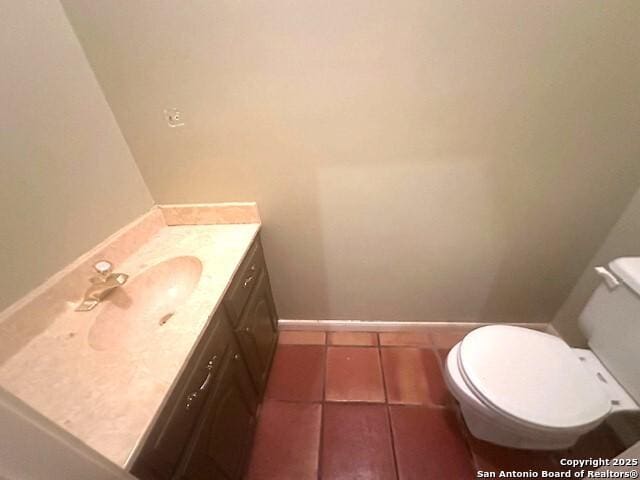 bathroom with tile patterned floors, vanity, and toilet