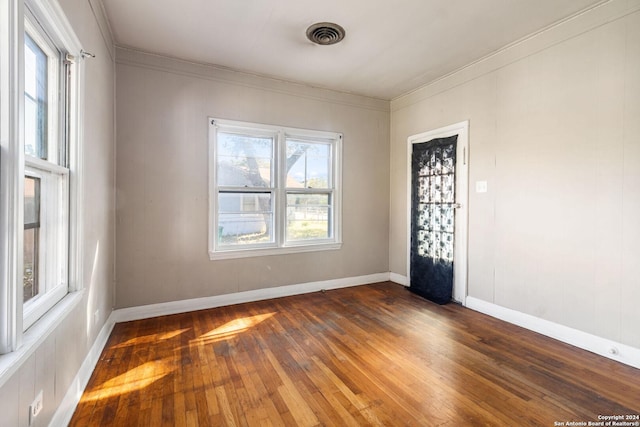 unfurnished room featuring crown molding and dark hardwood / wood-style flooring