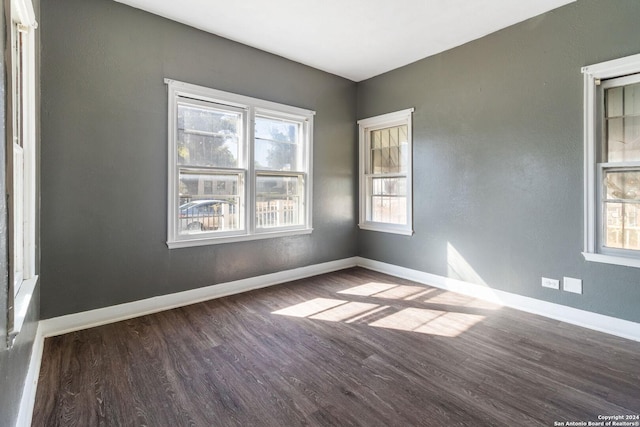 spare room featuring dark wood-type flooring