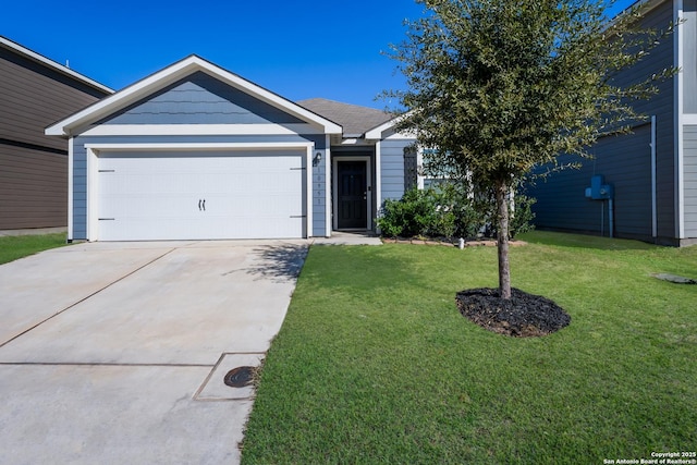 ranch-style house featuring a garage and a front lawn