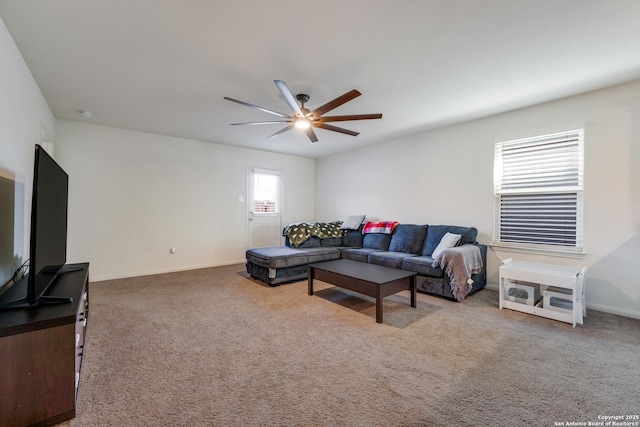 carpeted living room with ceiling fan