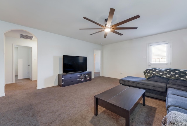 living room featuring ceiling fan and carpet