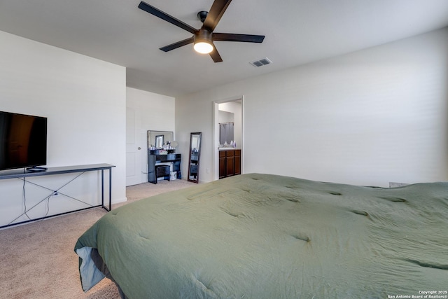 carpeted bedroom featuring ceiling fan and ensuite bath