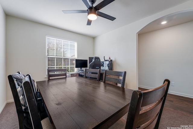 carpeted dining area featuring ceiling fan