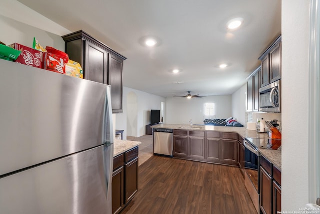 kitchen with kitchen peninsula, appliances with stainless steel finishes, dark brown cabinetry, and ceiling fan