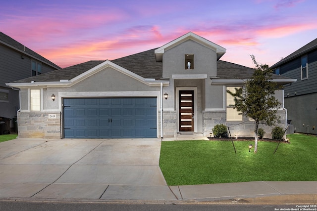 view of front facade featuring a garage and a lawn