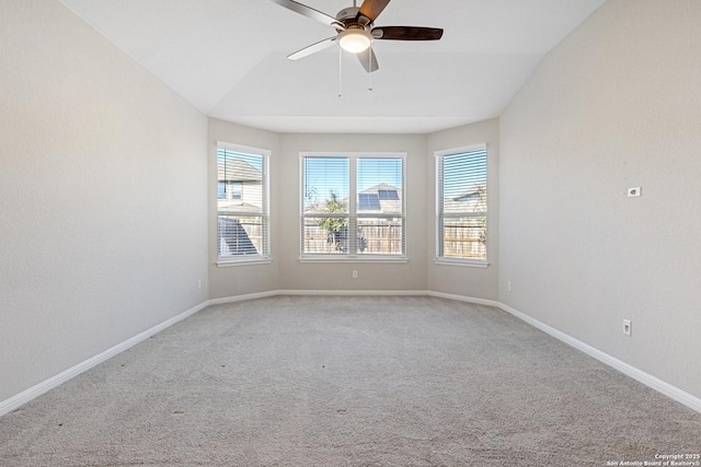 carpeted spare room with vaulted ceiling and ceiling fan