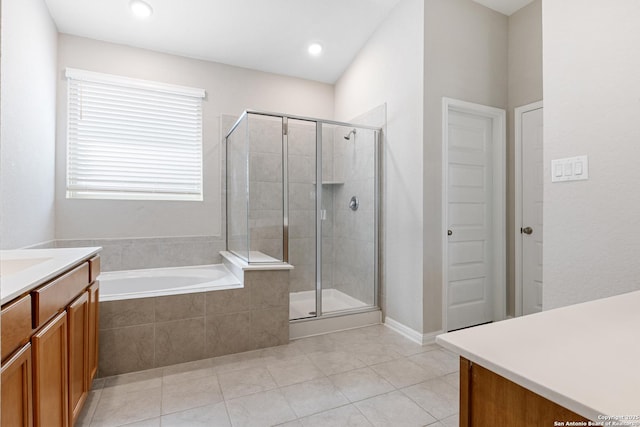 bathroom with plus walk in shower, vanity, and tile patterned floors