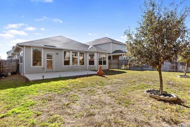 rear view of property with a patio area and a yard