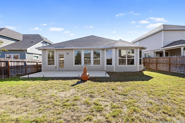 back of property with a patio area and a lawn