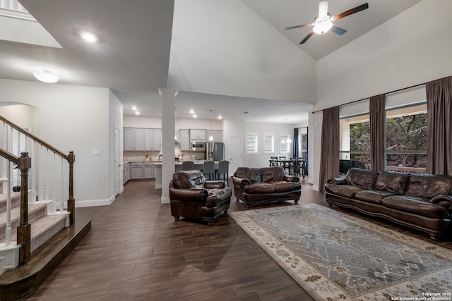 living room featuring ceiling fan and high vaulted ceiling