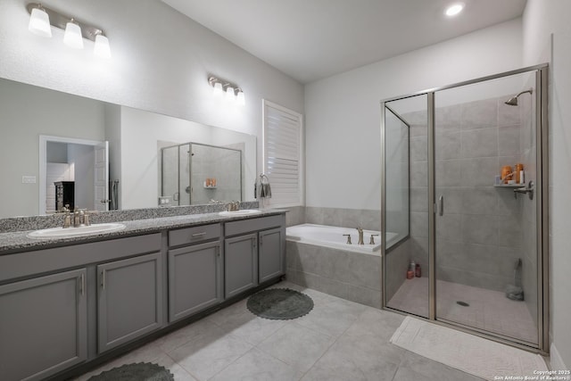 bathroom with vanity, tile patterned flooring, and plus walk in shower