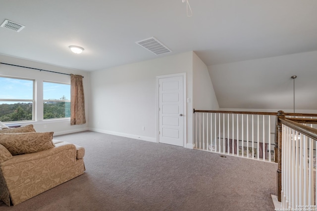 sitting room featuring carpet and lofted ceiling