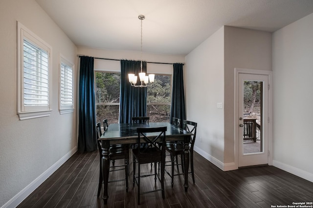 dining room featuring dark hardwood / wood-style floors and an inviting chandelier