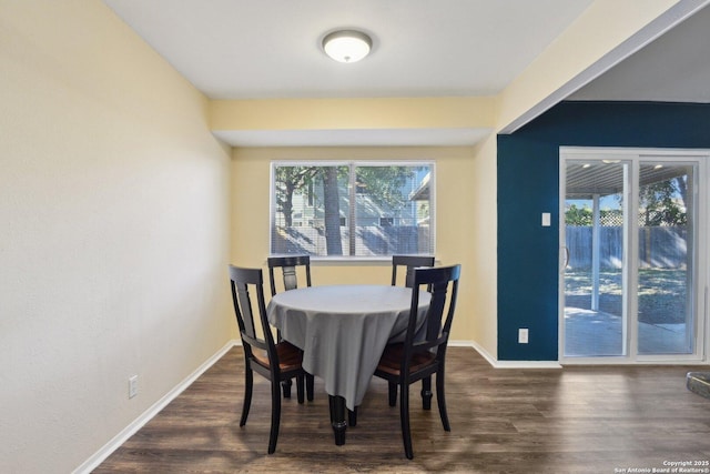 dining room with dark hardwood / wood-style flooring