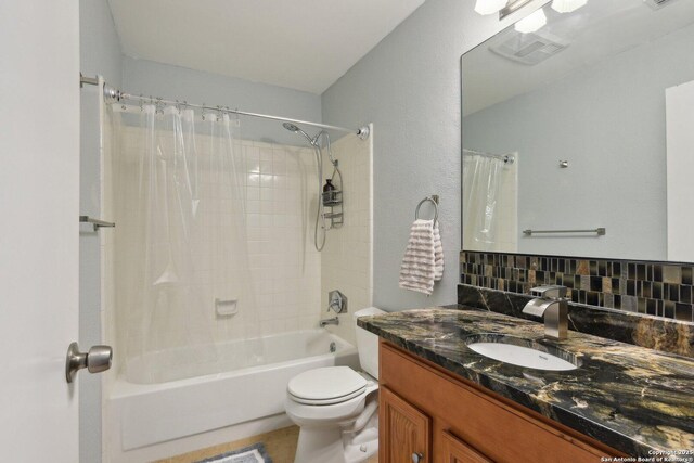 full bathroom with vanity, backsplash, toilet, and shower / bath combo with shower curtain