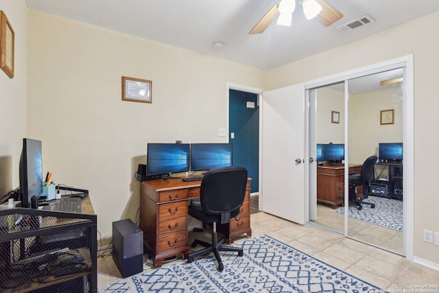 home office with ceiling fan and light tile patterned floors