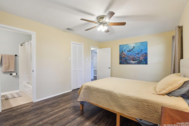 bedroom featuring ensuite bathroom, ceiling fan, dark hardwood / wood-style floors, and a closet