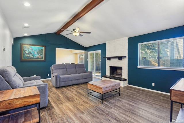 living room with dark hardwood / wood-style flooring, lofted ceiling with beams, a brick fireplace, and ceiling fan