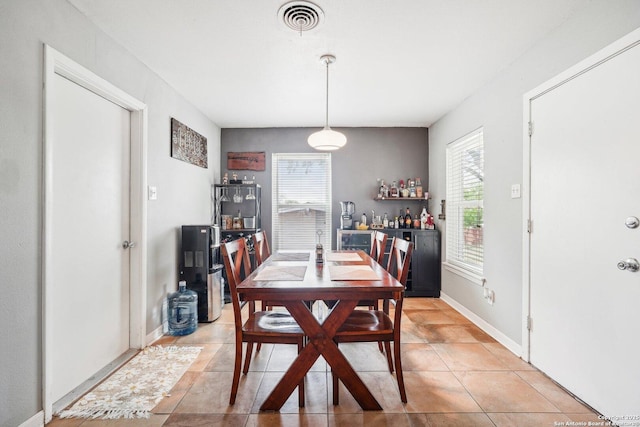 dining room with tile patterned flooring and a wealth of natural light