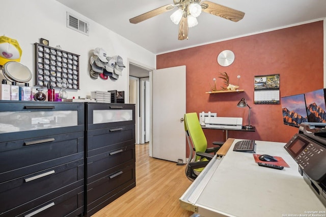 home office with crown molding, light hardwood / wood-style flooring, and ceiling fan