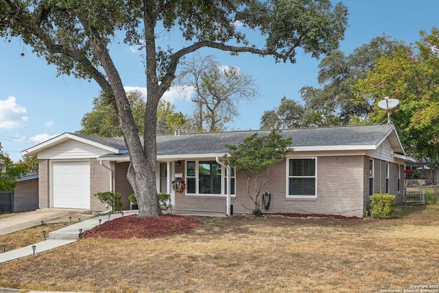 ranch-style home with a garage and a front lawn