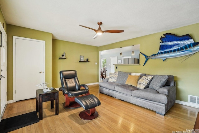 living room with ceiling fan and wood-type flooring