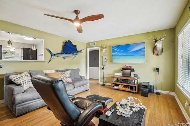 living room featuring ceiling fan and wood-type flooring