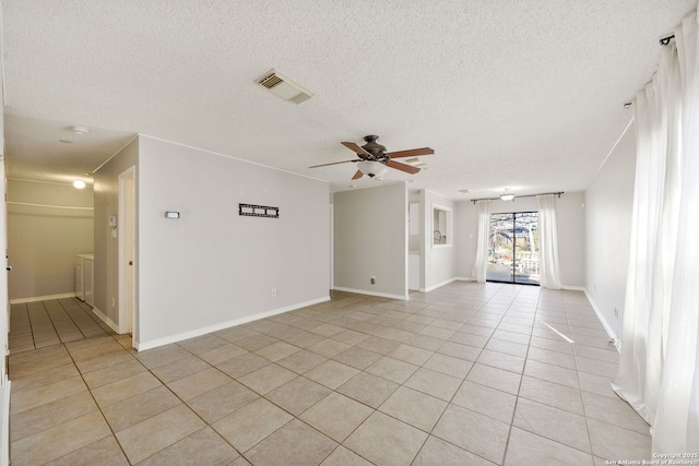 tiled spare room featuring ceiling fan and a textured ceiling