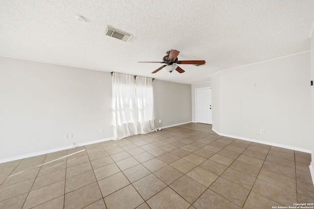 tiled spare room with ceiling fan and a textured ceiling