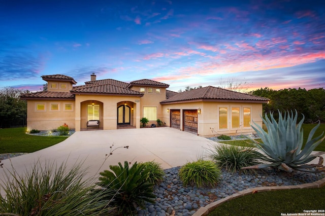 mediterranean / spanish house featuring a garage