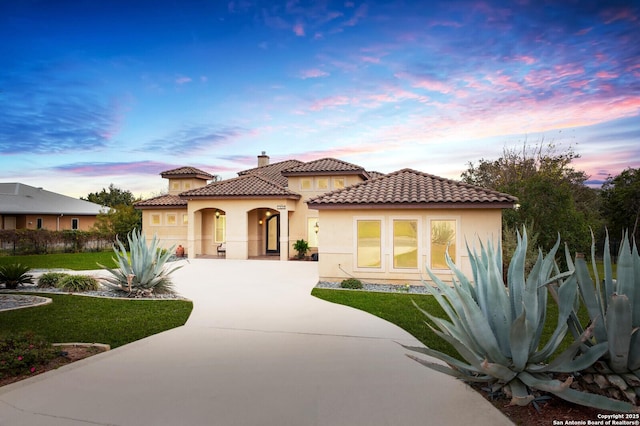 mediterranean / spanish-style house featuring a lawn