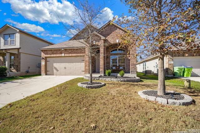 view of front of home with a garage, central air condition unit, and a front lawn