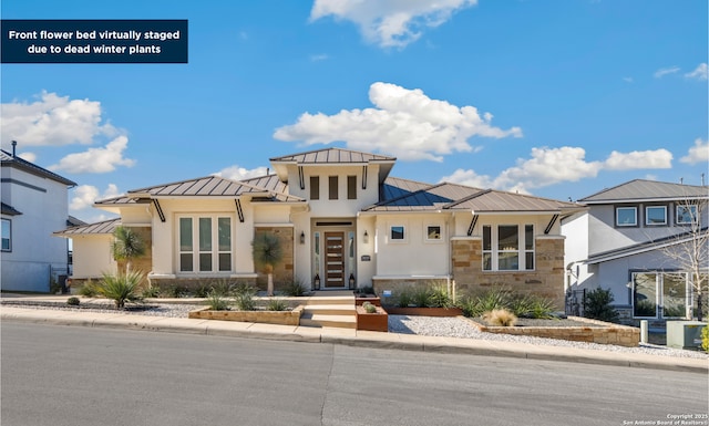 view of front of property with metal roof, a standing seam roof, stone siding, and stucco siding