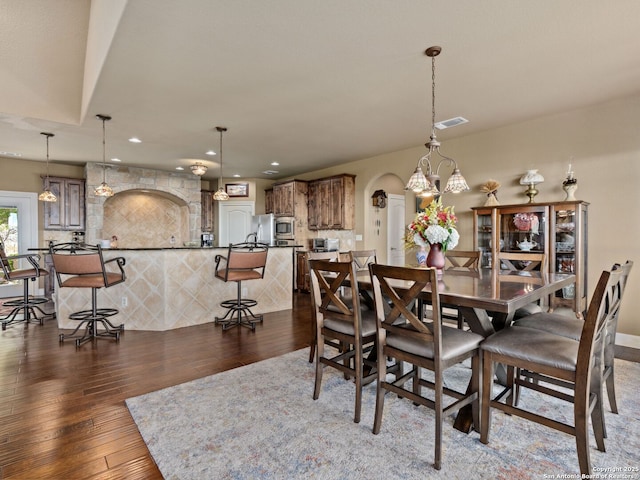 dining area with dark hardwood / wood-style flooring