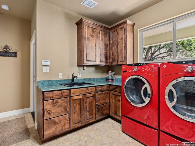 laundry room with sink, cabinets, and independent washer and dryer