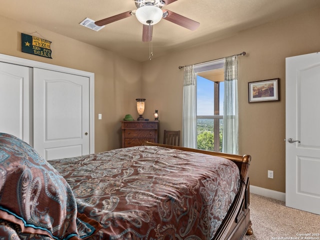 carpeted bedroom with a closet and ceiling fan