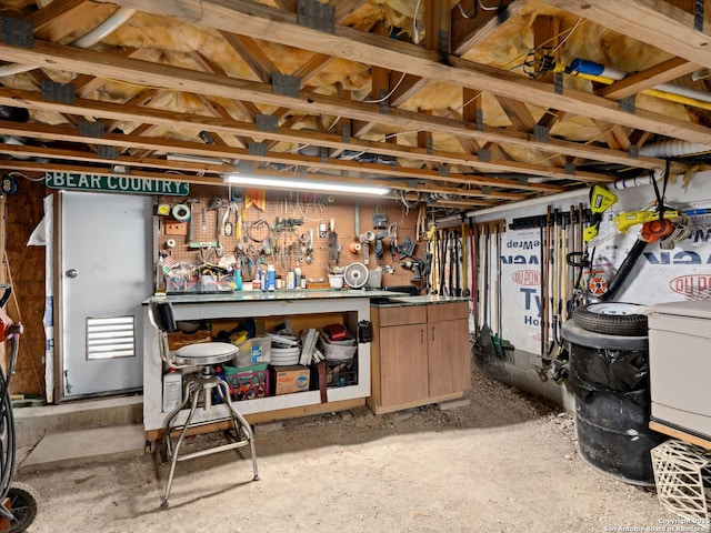 basement with a workshop area and washer / dryer