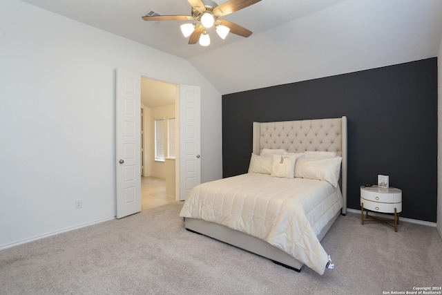 bedroom featuring ceiling fan, light carpet, and vaulted ceiling