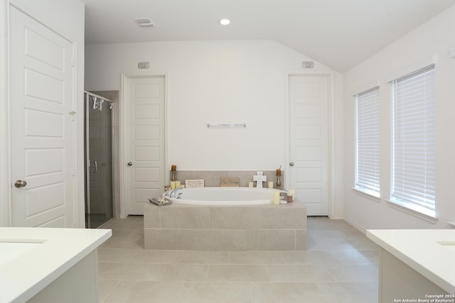 bathroom featuring tile patterned flooring, vanity, separate shower and tub, and vaulted ceiling