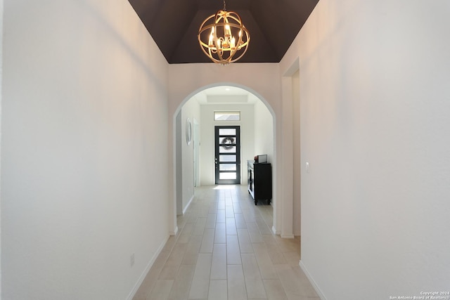 hall featuring a chandelier and a high ceiling