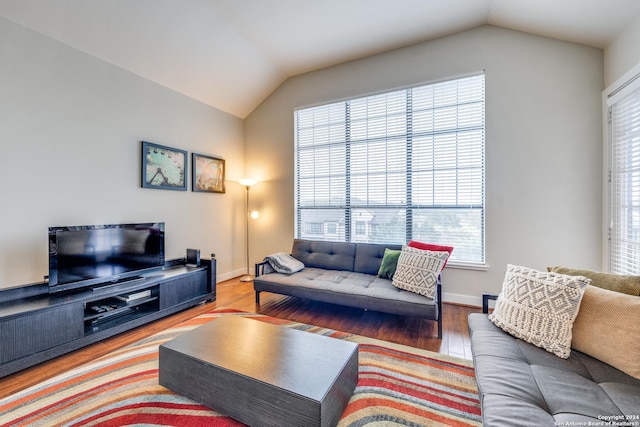 living room featuring vaulted ceiling and wood-type flooring