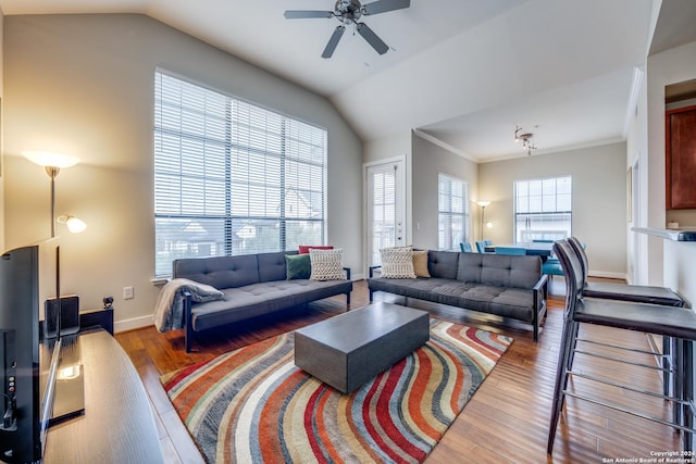 living room featuring vaulted ceiling, ornamental molding, hardwood / wood-style floors, and ceiling fan