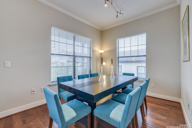 dining room with crown molding, a healthy amount of sunlight, and dark hardwood / wood-style flooring