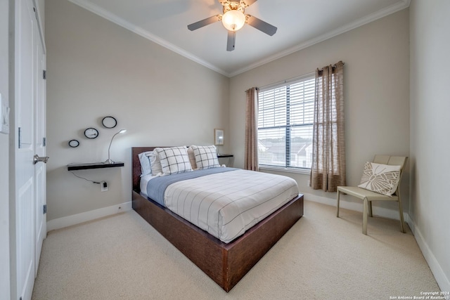 carpeted bedroom featuring crown molding and ceiling fan