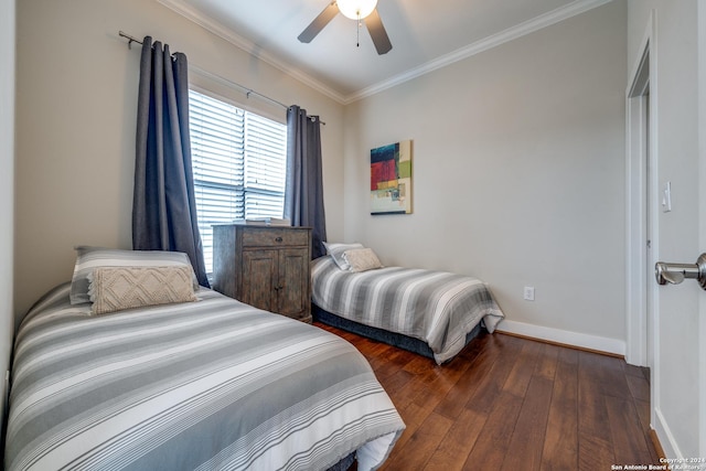 bedroom with dark hardwood / wood-style flooring, crown molding, and ceiling fan