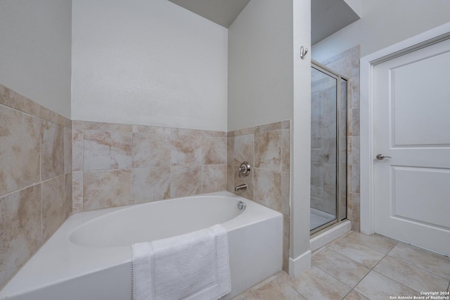 bathroom with tile patterned floors and shower with separate bathtub