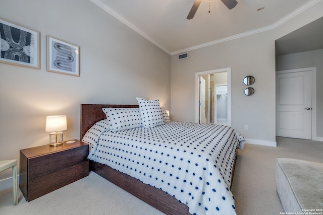 bedroom with ornamental molding, connected bathroom, light carpet, and ceiling fan